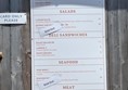 Image of a menu on a wood surface