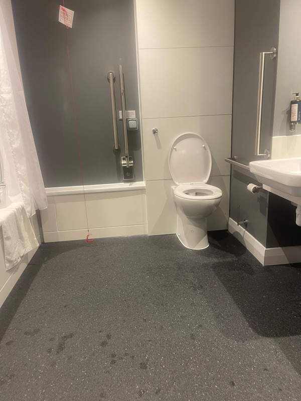 This photo shows the toilet tucked in against the wall and positioned right next to the wash hand basin. The red cord was originally tied up, I managed to untie it and I have placed a Red cord Card on the cord.