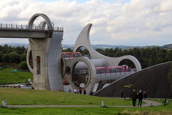 View of the wheel from the car park, with both boats on it. It's half turned.