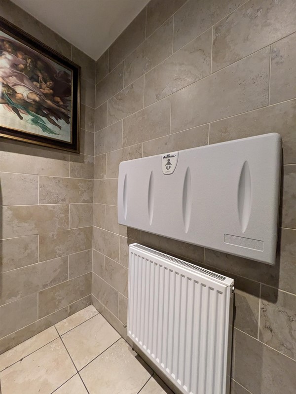 Image of the wall-mounted baby change in the accessible toilet