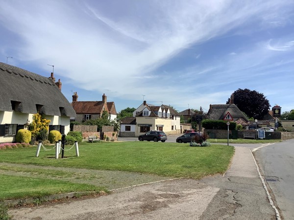 Picture of a road going by some houses on the left