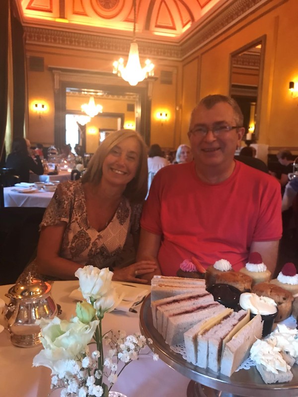 Picture of two people with a tray of sandwiches