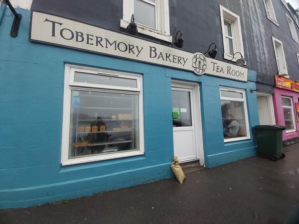 Image of a blue building with a sign on the side