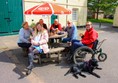 Outdoor seating area with plenty of space for a large family or group. Parasols are there providing shade.