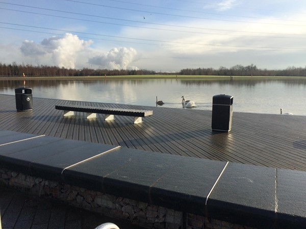 Walking and seating areas around the water.