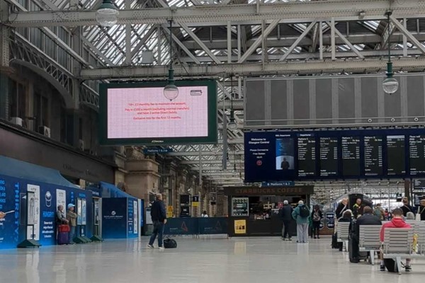 A large screen in the station