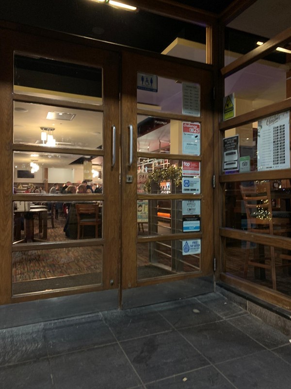 Exterior of restaurant showing handles to get in and width of door