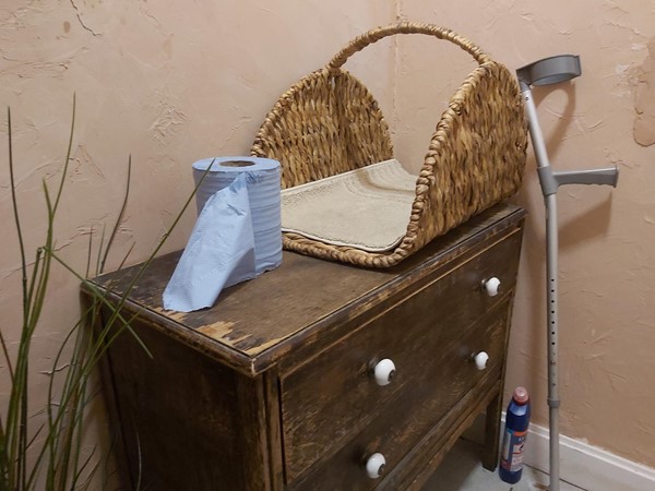 Picture of a toilet roll on a chest of drawere