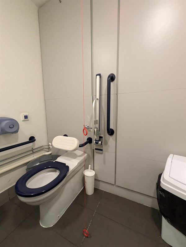 Image of toilet and Red Card Cord in the accessible toilet