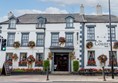 This is the exterior front of the County Hotel, the side entrance, which is accessible to the right hand side, as you look at the photograph up  the sidestreet