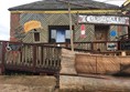 Image of the outside of Cairn O'Mohr showing the ramp going up to the platform and the wheelchair drop off area beside the car park.