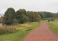 Lovely wide flat path on the other side of the lake. The surface is compressed gravel but it has a topping of something soft.