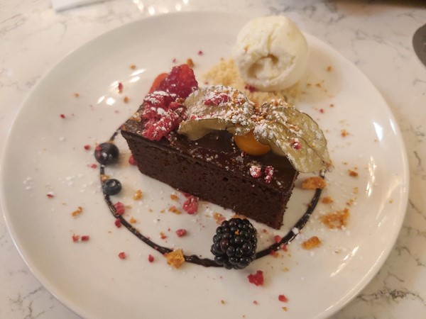 Image of a plate of dessert with ice cream and berries