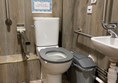 Image of an accessible toilet and a sink.