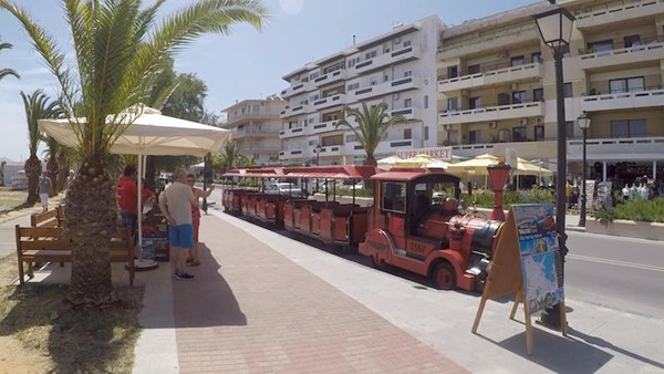 The Little Red Train at a train stop