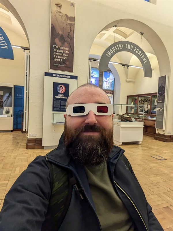 Image of Joe, a white man with a shaved head and brown beard wearing 3D Glasses