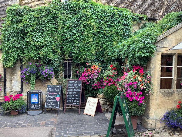 Flower laden attractive THE PLOUGH INN at Ford