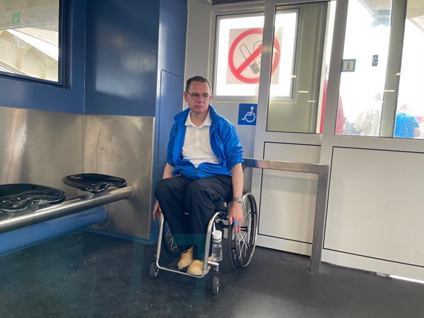 Paul sitting in the dedicated wheelchair space on the Buiksloterweg ferry