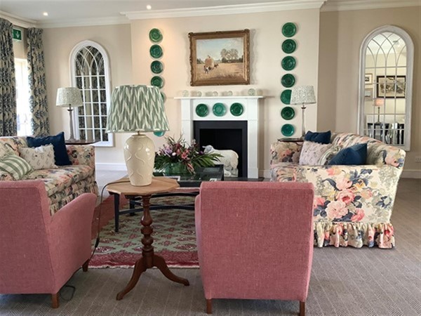 Image of a  living room with a fireplace and couches