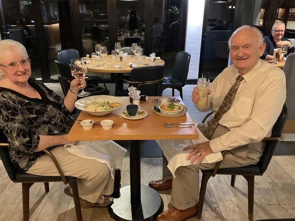 Image of two people in a restaurant.