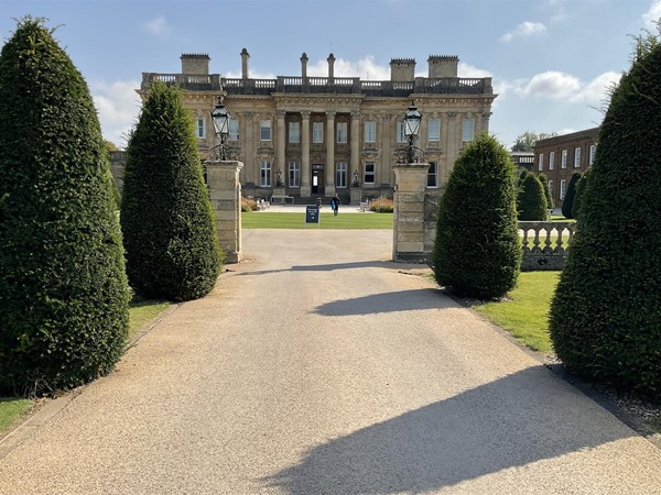 Image of a large building with a lawn and trees