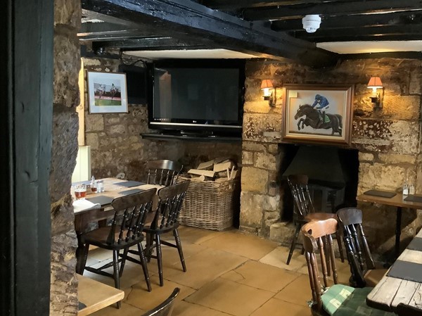 Image of a room with a stone wall and a television