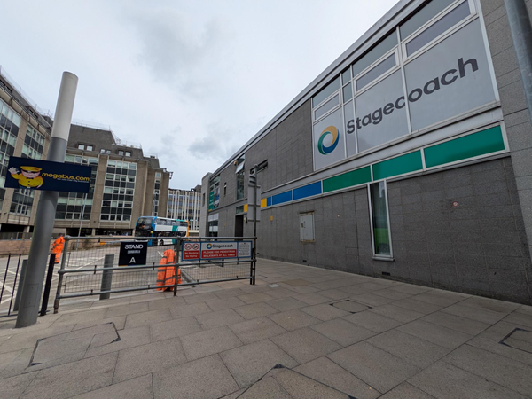 External image of the bus station. Grey slabs against a grey building with the Stagecoach logo printed across the windows.