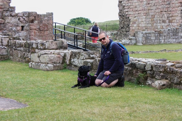 Hubby and assistance dog taking a rest on the grass. Behind them is the ramp that bridges the two sections of the grounds.