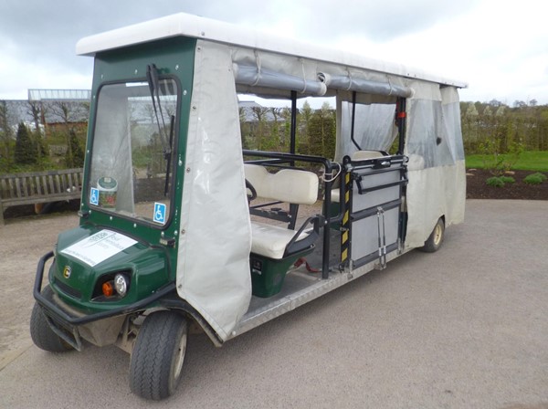 Mobility vehicle with clamps for wheelchair.