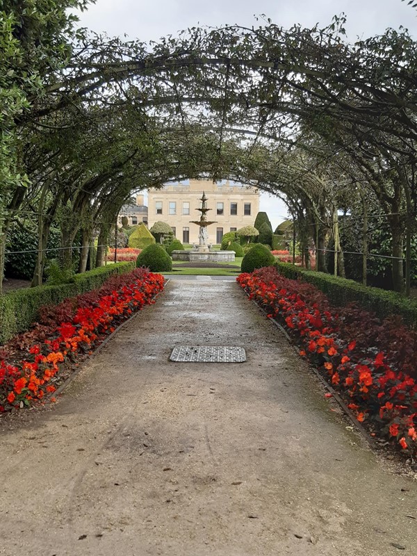 Picture of a garden path going under an archway