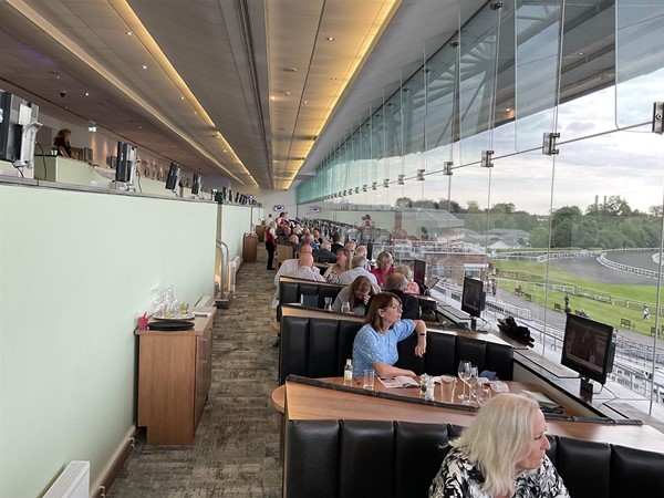 Image of people sitting at tables in a room