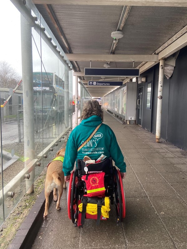 Image of a wheelchair user and assistance dog at Bristol Airport