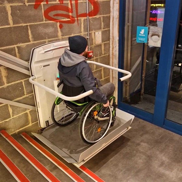 Image of a wheelchair user on the stairlift