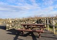 Picnic benches in a corner of the path.