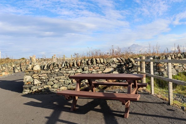 Picnic benches in a corner of the path.