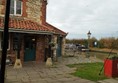 Picture of stone slabs and the back door of a pub