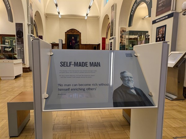 Image of signage with an image of Andrew Carnegie in the Andrew Carnegie Birth Museum