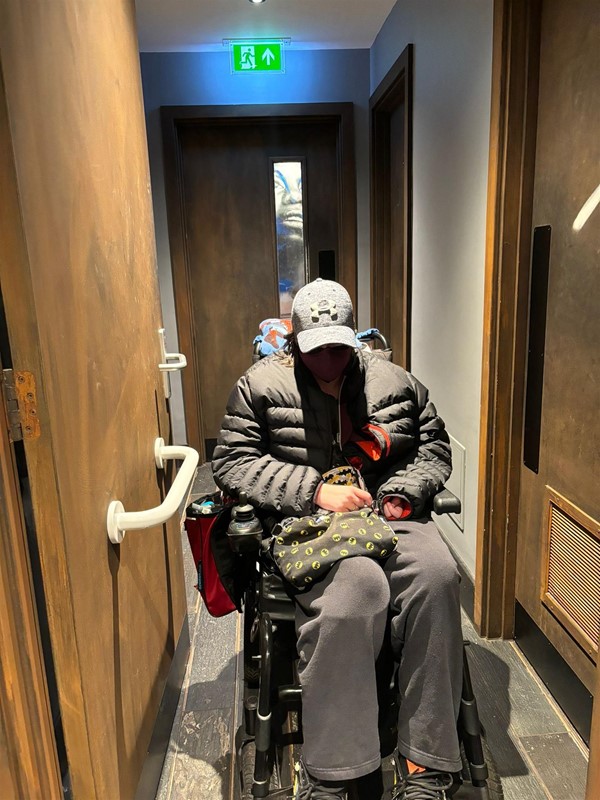 Image of a person in a wheelchair in a corridor