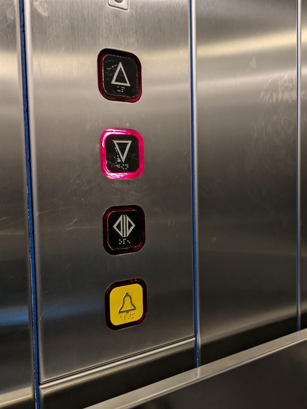 Image of lift buttons. The lift buttons have Braille Markings