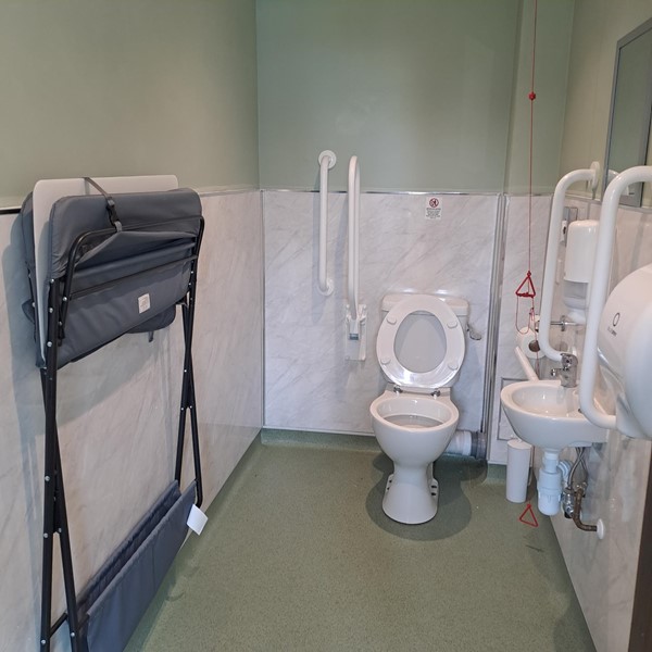 Image of an accesible toilet with an emergency red cord