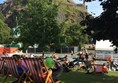 Photo of deck chairs in West Princes Street Gardens beneath the castle.