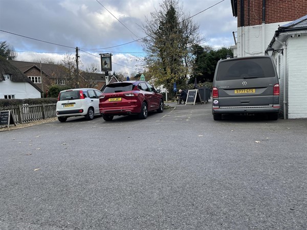 Image of two cars and a van in a carpark