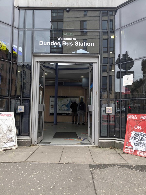 A bus station with a sign