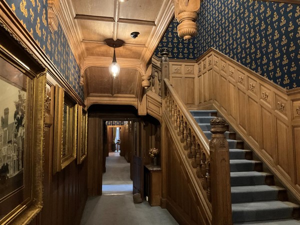 show you the very delightful wooden carved staircase and hallway which is so becoming of this historical Mansion.