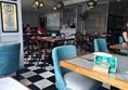 Photo of tables and chairs inside the restaurant.