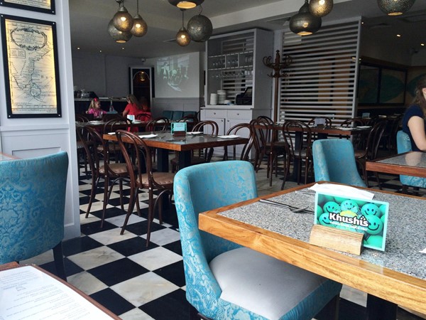 Photo of tables and chairs inside the restaurant.