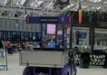 A purple mobility assistance vehicle in the station