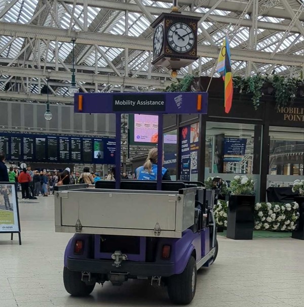 A purple mobility assistance vehicle in the station