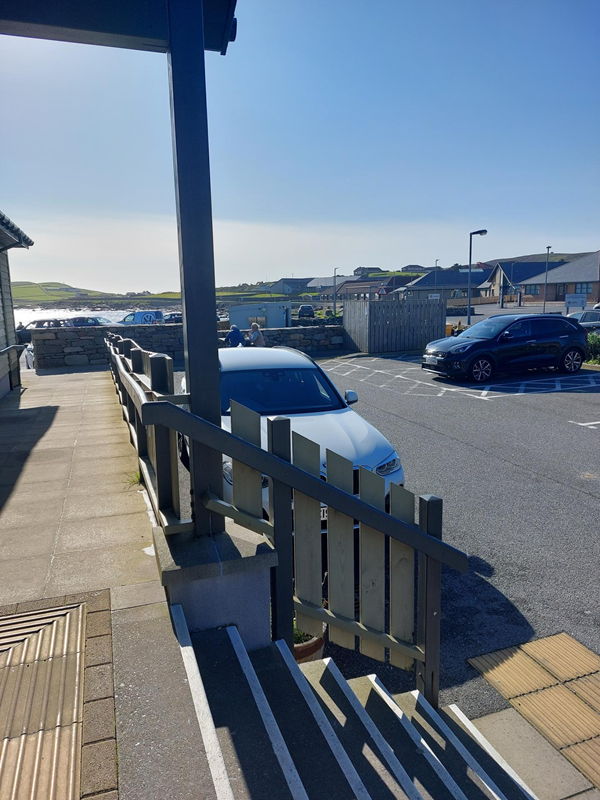 Taken  from top of ramp. Stairs to car park are to my right. You can see the 2 blue badge spaces.