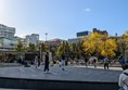 Image of the fountains, they're off and several men are seen throwing a bakk around.